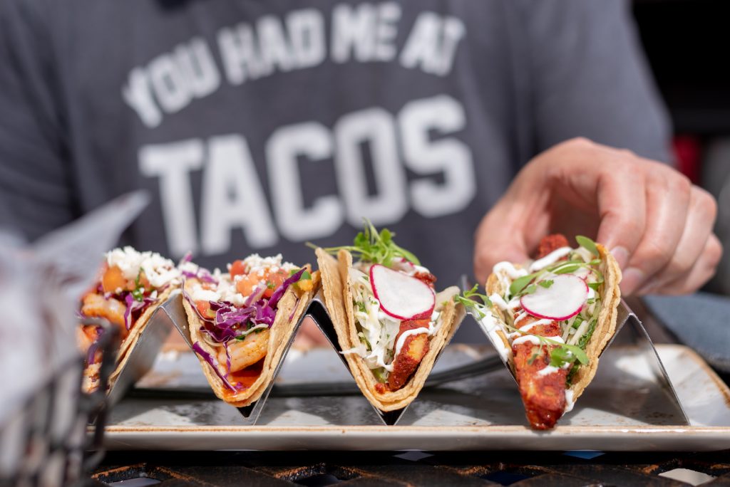 man eating tacos in summer